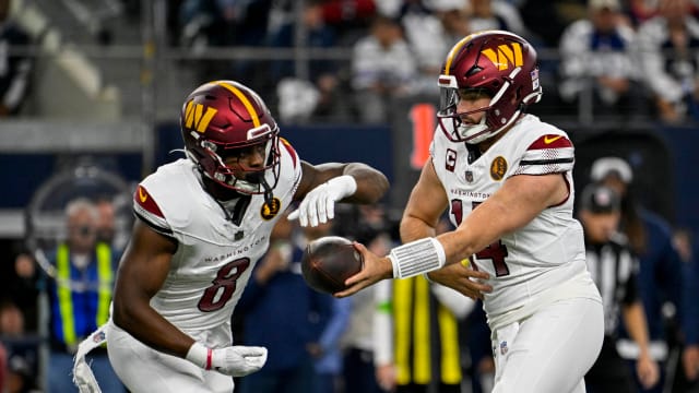 Washington Commanders running back Brian Robinson Jr. (8) and quarterback Sam Howell (14) in action during the game between the Dallas Cowboys and the Washington Commanders at AT&T Stadium.